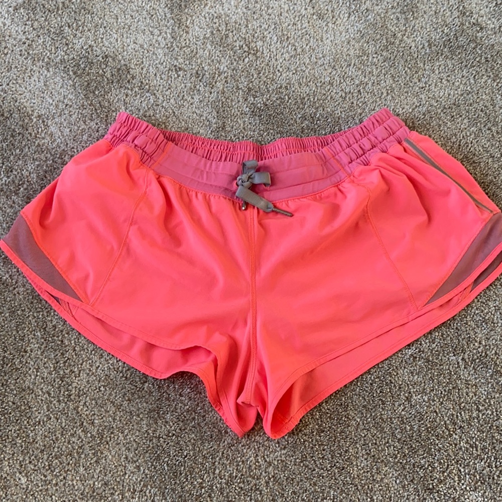 Neon coral Lululemon running shorts
